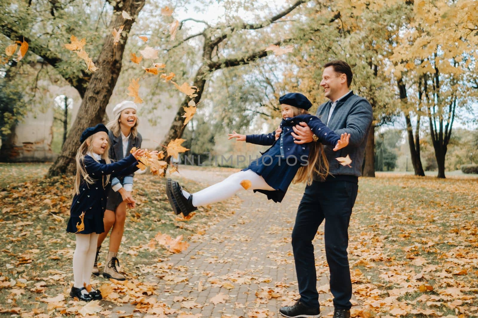 A large family walks in the park in the fall. Happy people in the autumn park.