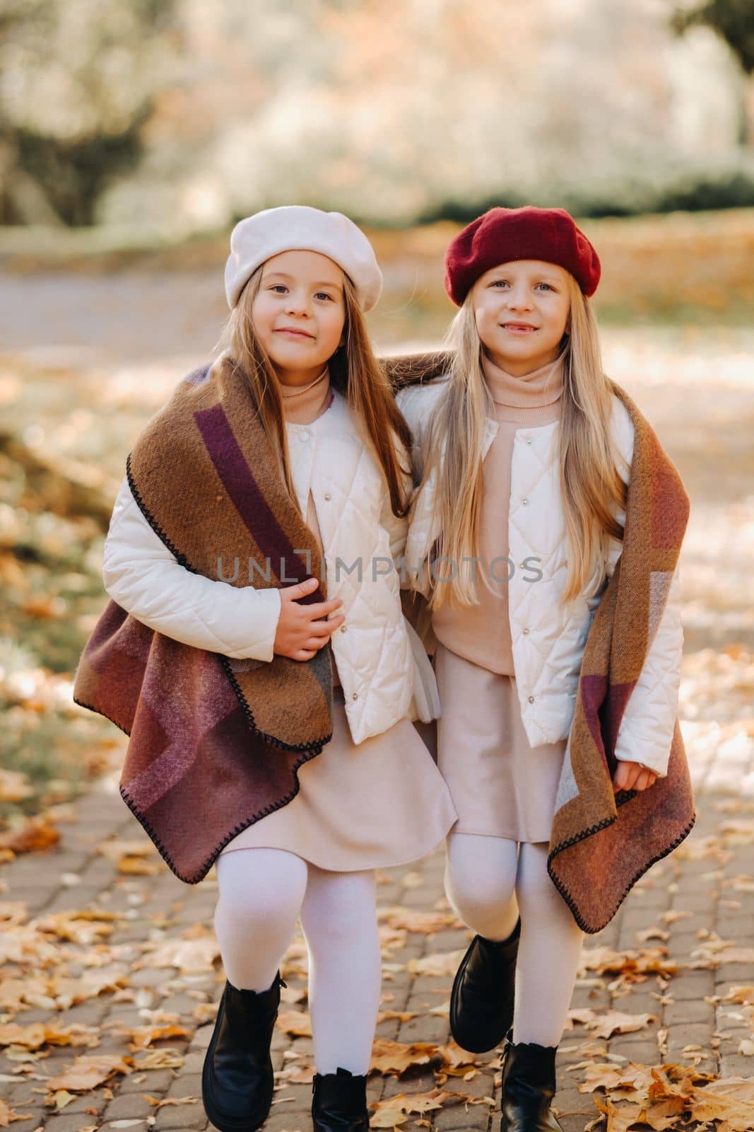 Happy children cuddling in a beautiful autumn park.