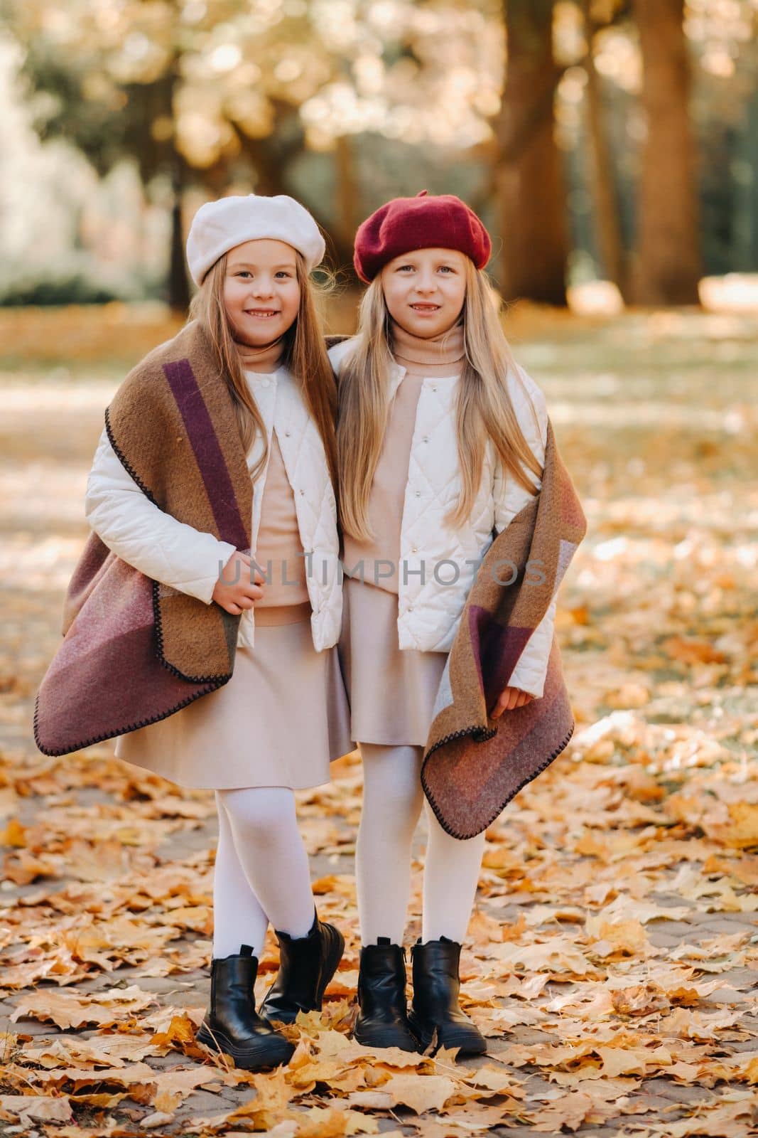 Happy children cuddling in a beautiful autumn park.