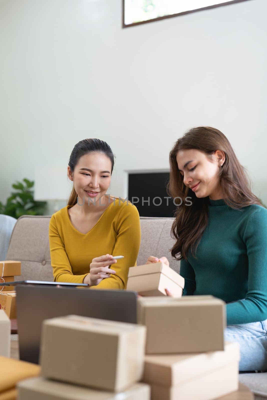 Two women busines startup for online marketing, Entrepreneur packing boxes parcels for shipping, SME sellers, and freelance online sales concept.