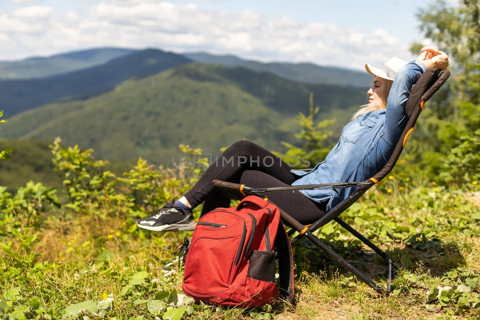 Tired middle age woman resting after hiking in nature.