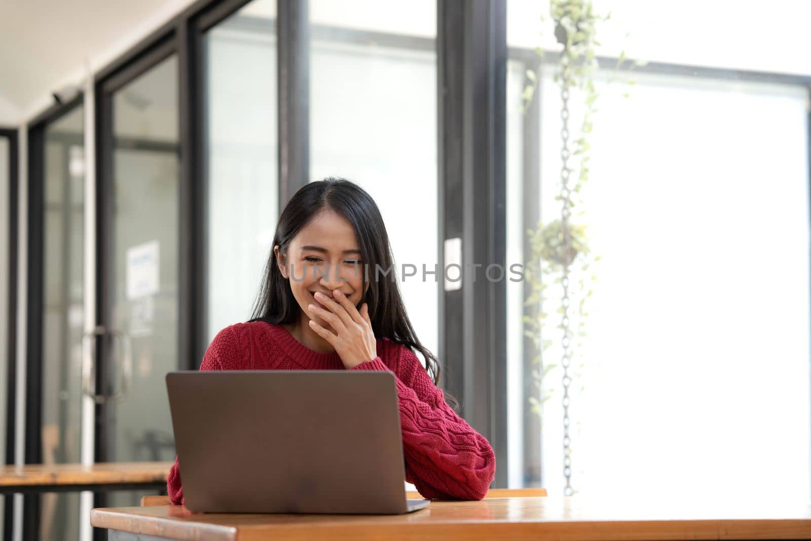 happy young asian pretty woman video call chat on digital laptop computer at caffee..