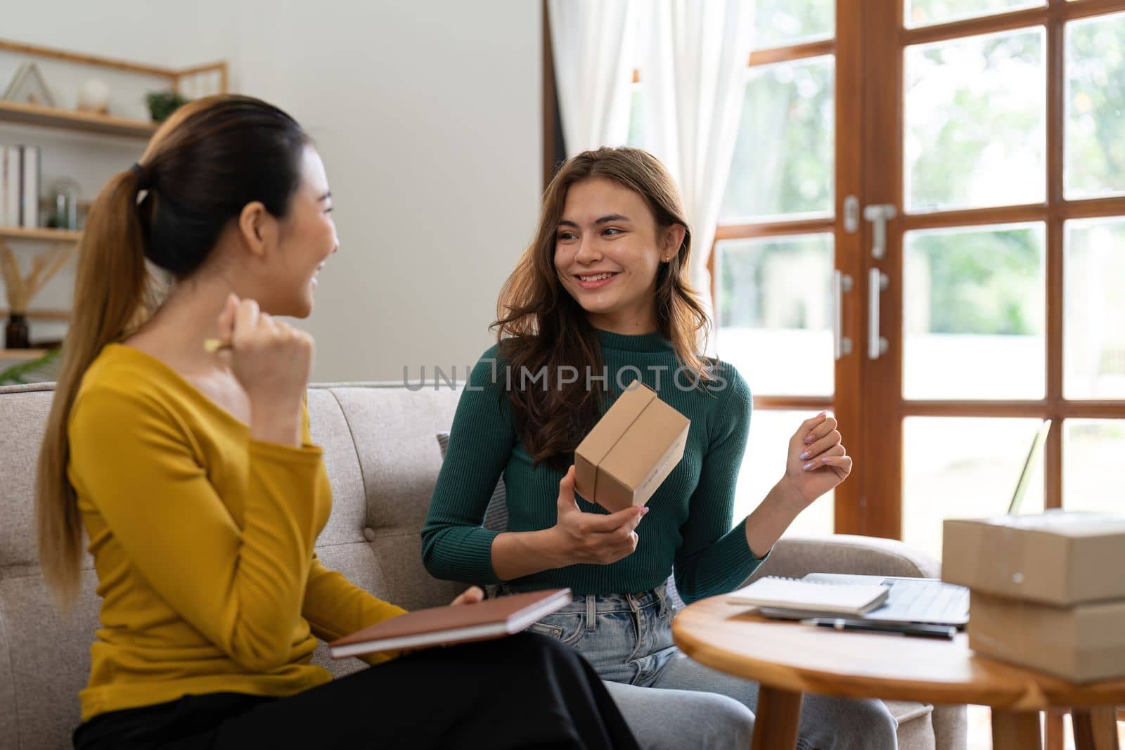 Two women busines startup for online marketing, Entrepreneur packing boxes parcels for shipping, SME sellers, and freelance online sales concept.