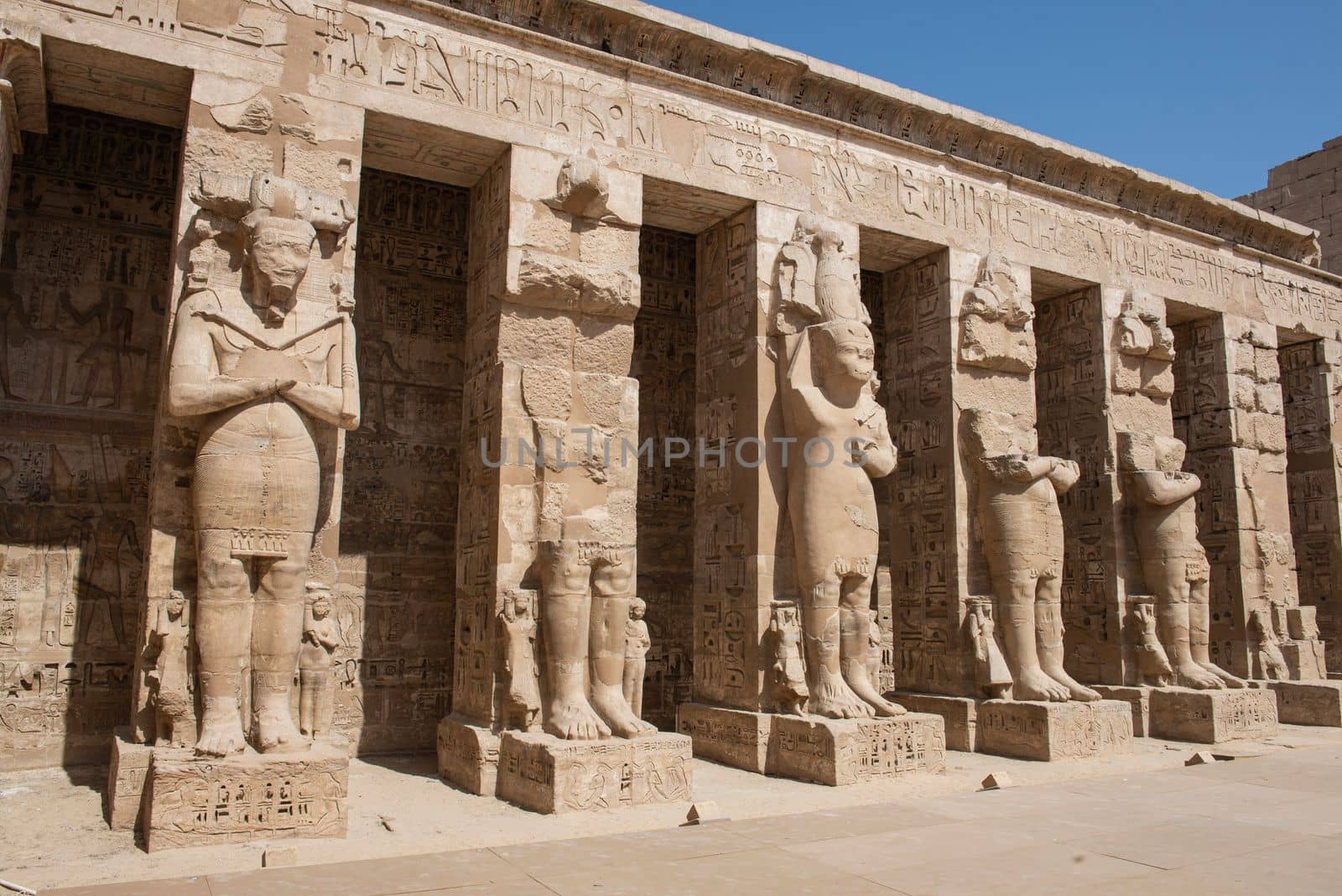 Large statues of Ramses 2nd at Medinat Habu temple in Egypt by paulvinten