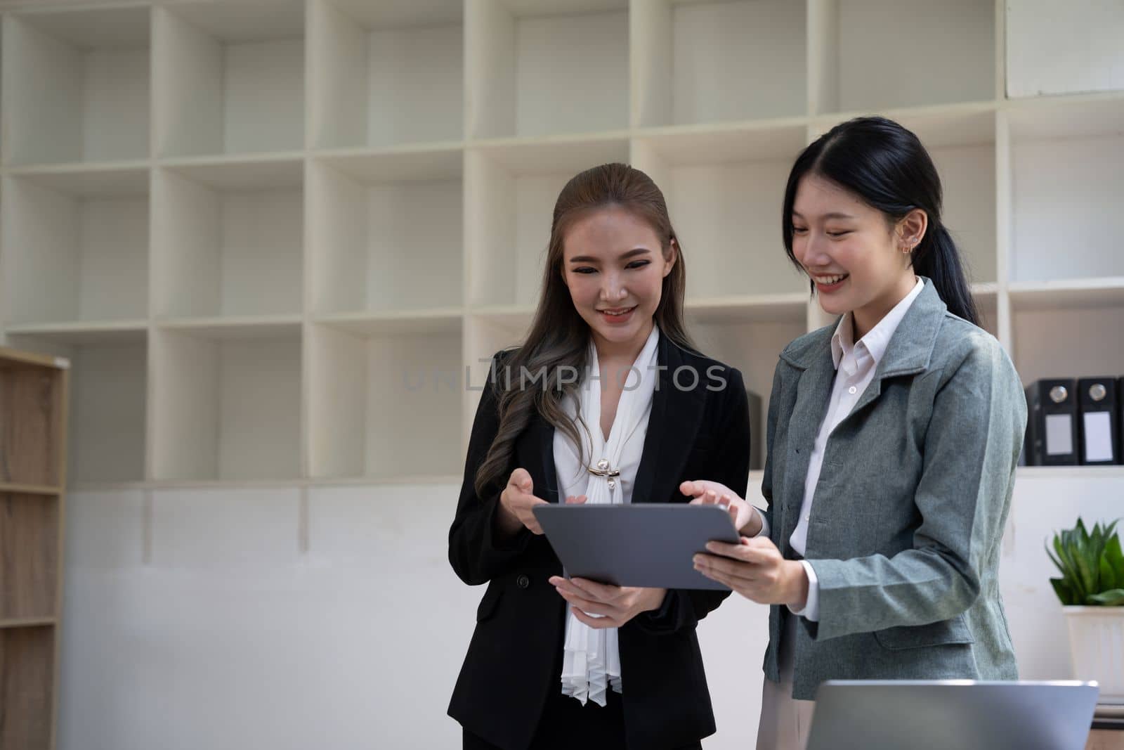diverse coworkers working together in boardroom, brainstorming, discussing and analyzing and planning business strategy