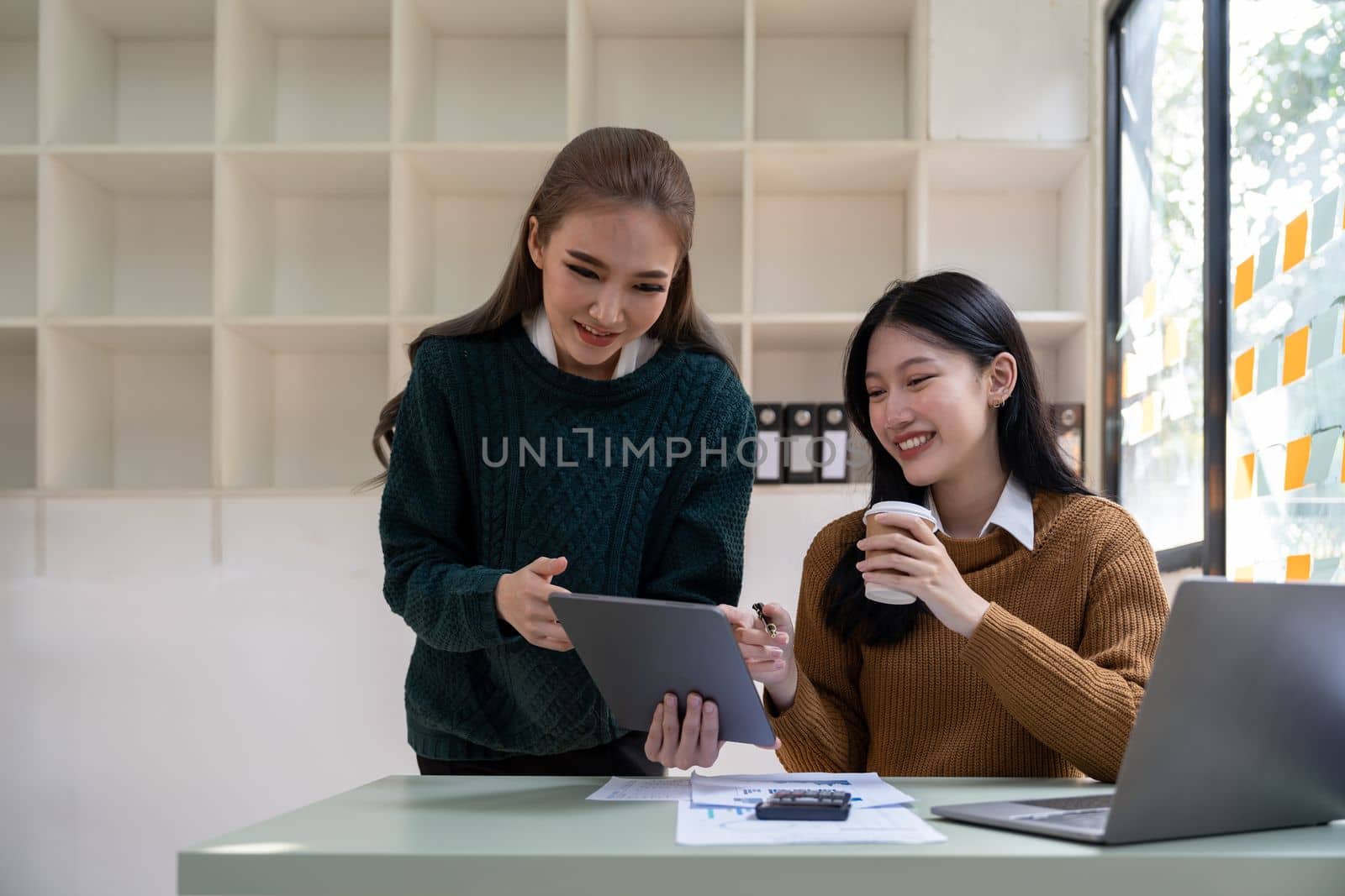 Asian business meeting to analyze and discuss the situation on the financial report in the meeting room. Investment Consultant, Financial advisor and accounting concept.