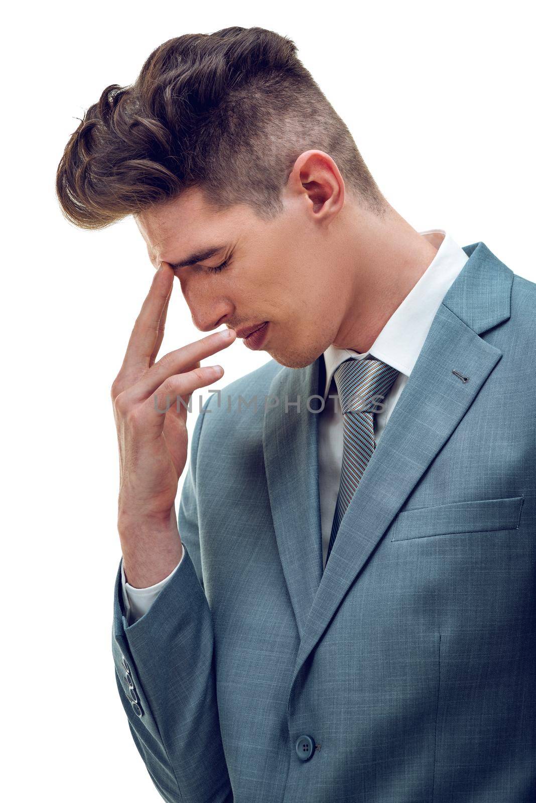 Frustrated overworked businessman worries about business problems, holding his finger on his forehead, isolated on white background. 