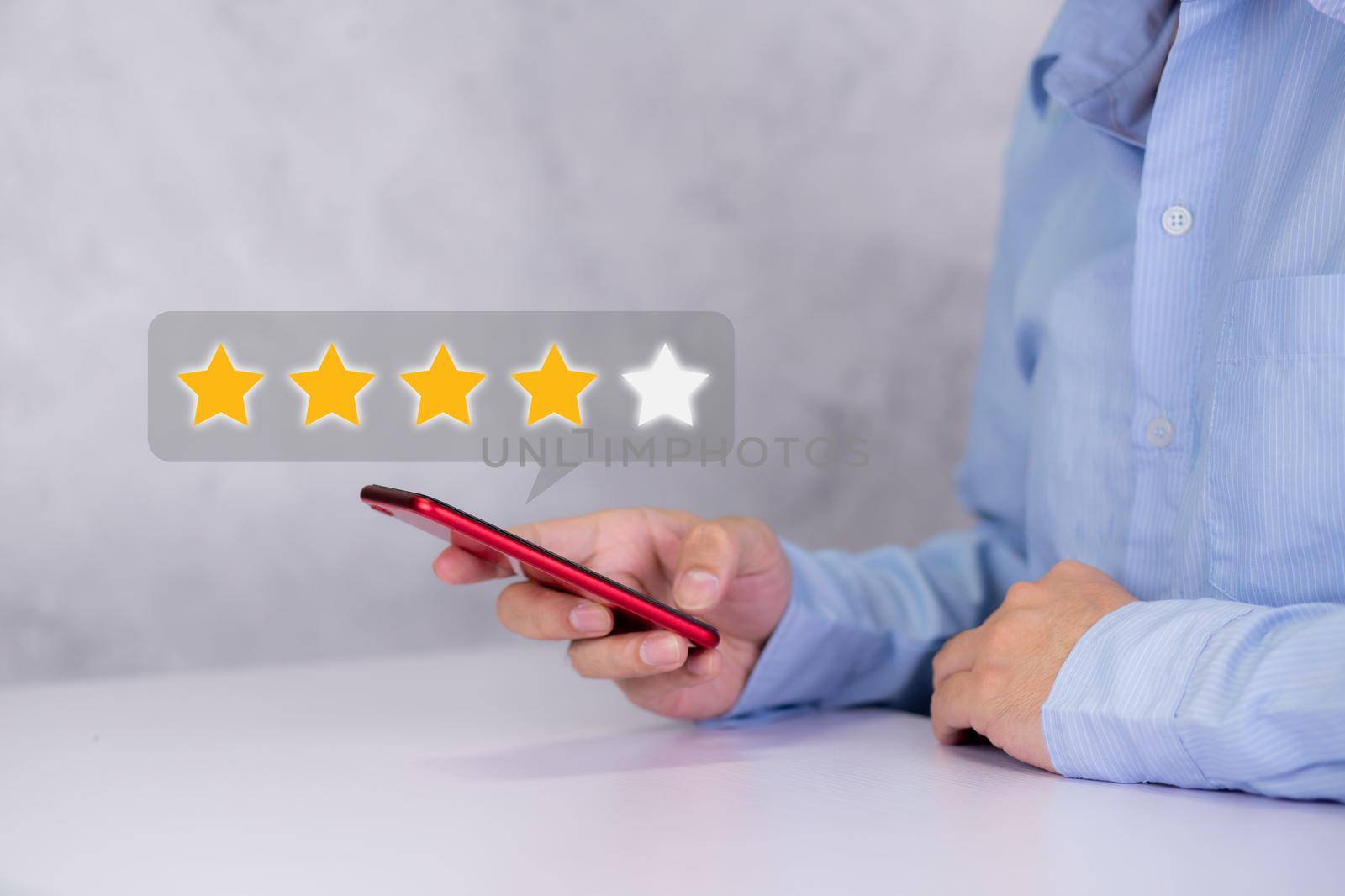 Customer holding phone and pressing star icon for vote score review and feedback with quality and satisfaction, success of digital marketing with result excellent for ranking of service. by nnudoo