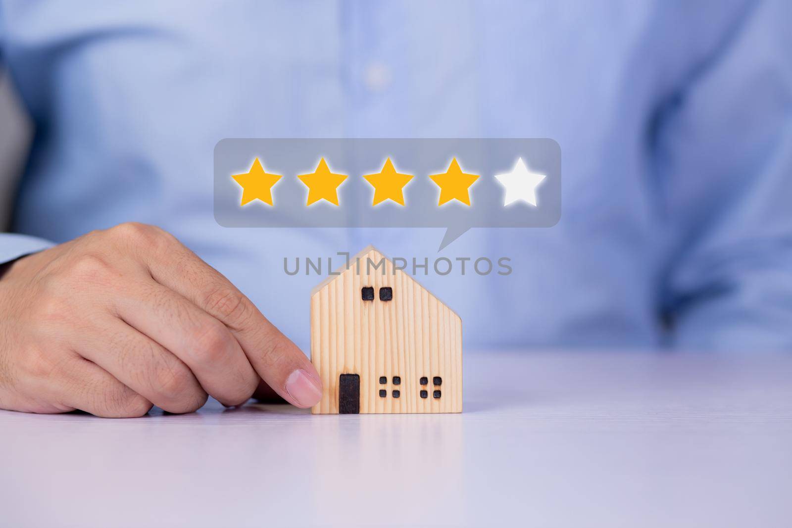 Hands of businessman holding home model with choice for satisfaction and score of guarantee and vote, review and feedback of property, survey and rating, investment of real estate business concepts. by nnudoo