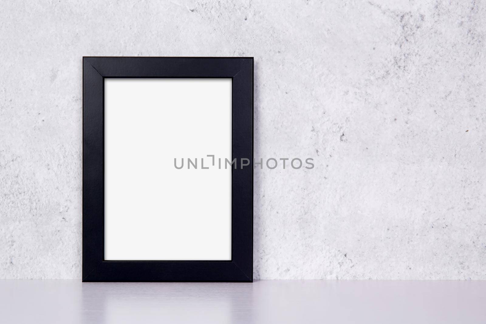 Mockup black frame vertical on table top and wall at home, mock up poster for presentation on desk, your design for gallery photo and picture image, border template and decoration for advertising. by nnudoo