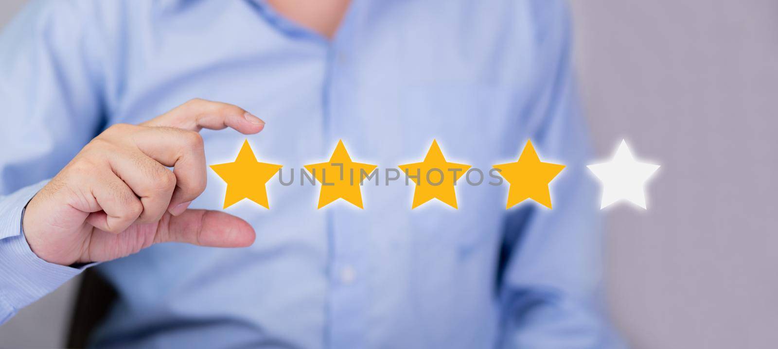 Customer business man holding star icon symbol for vote score review and feedback with quality and satisfaction, success of digital marketing with result excellent for ranking of service. by nnudoo