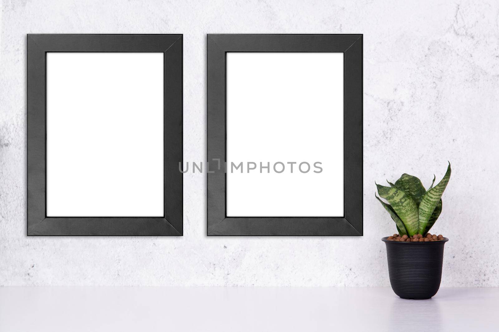 Mockup black frame vertical on the wall and plants in pot on table top at home, mock up poster for presentation on desk, your design for gallery photo and picture, border template for advertising. by nnudoo