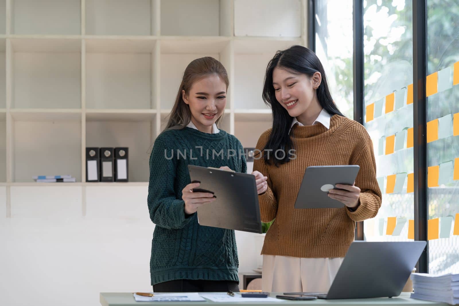 diverse coworkers working together in boardroom, brainstorming, discussing and analyzing and planning business strategy