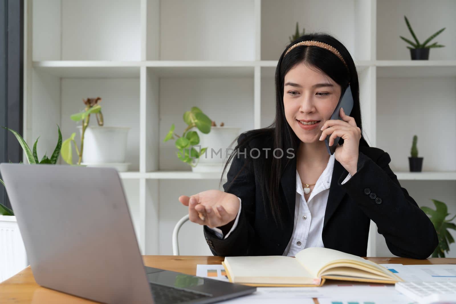 Close up Young Office asian Woman Talking to Someone on her Mobile Phone While Looking Into the Distance with Happy Facial Expression