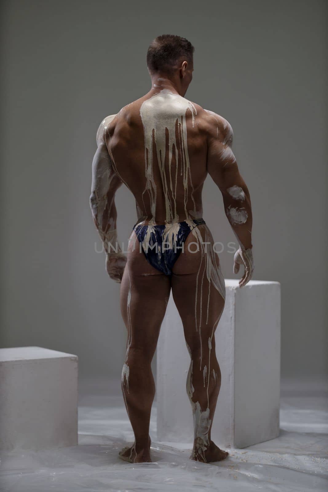 Sexy male back view of shirtless athletic strong man at studio by but_photo