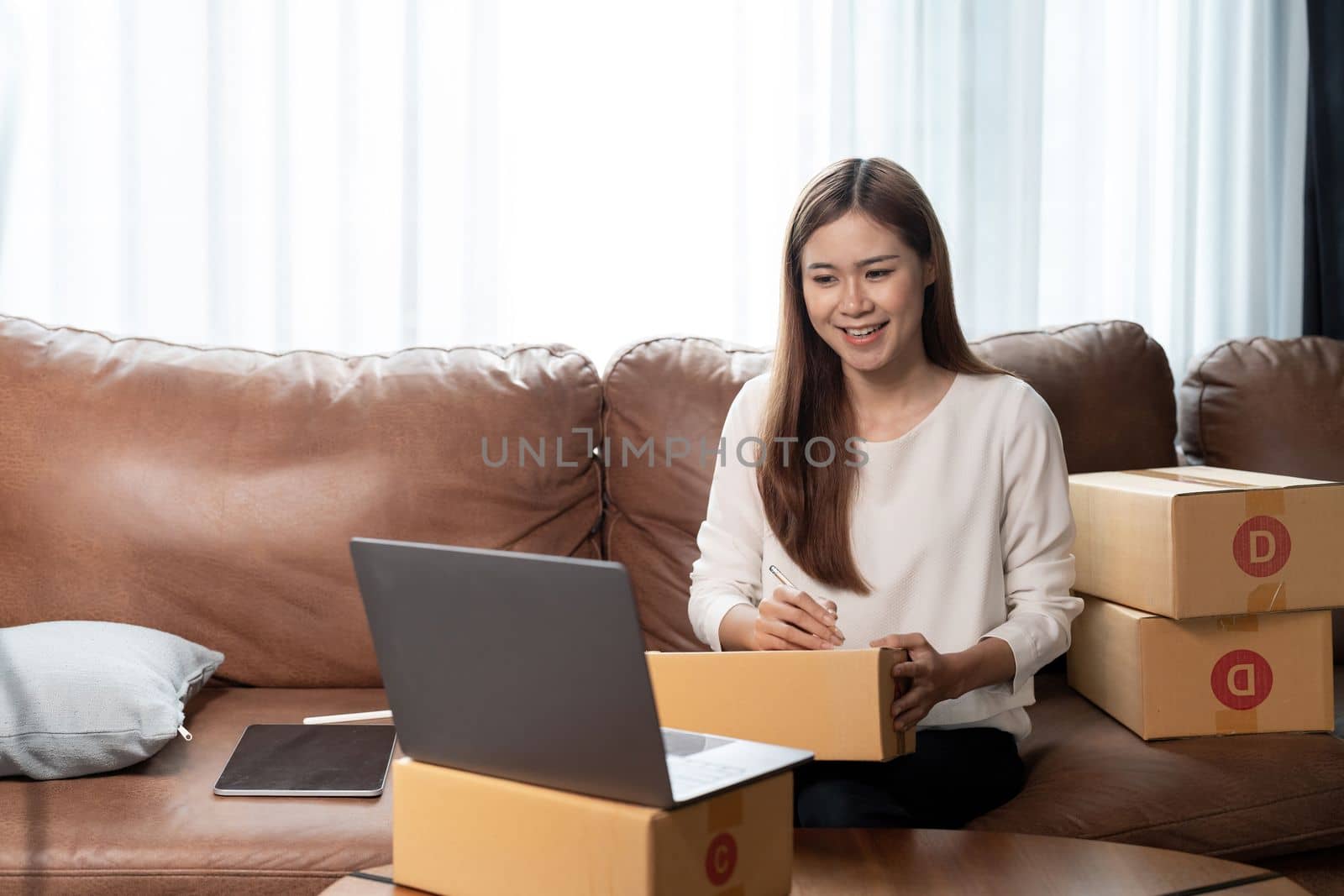 Portrait asian woman packing box. small business owner in home office, online sell marketing delivery, SME e-commerce telemarketing Startup small business entrepreneur concept.
