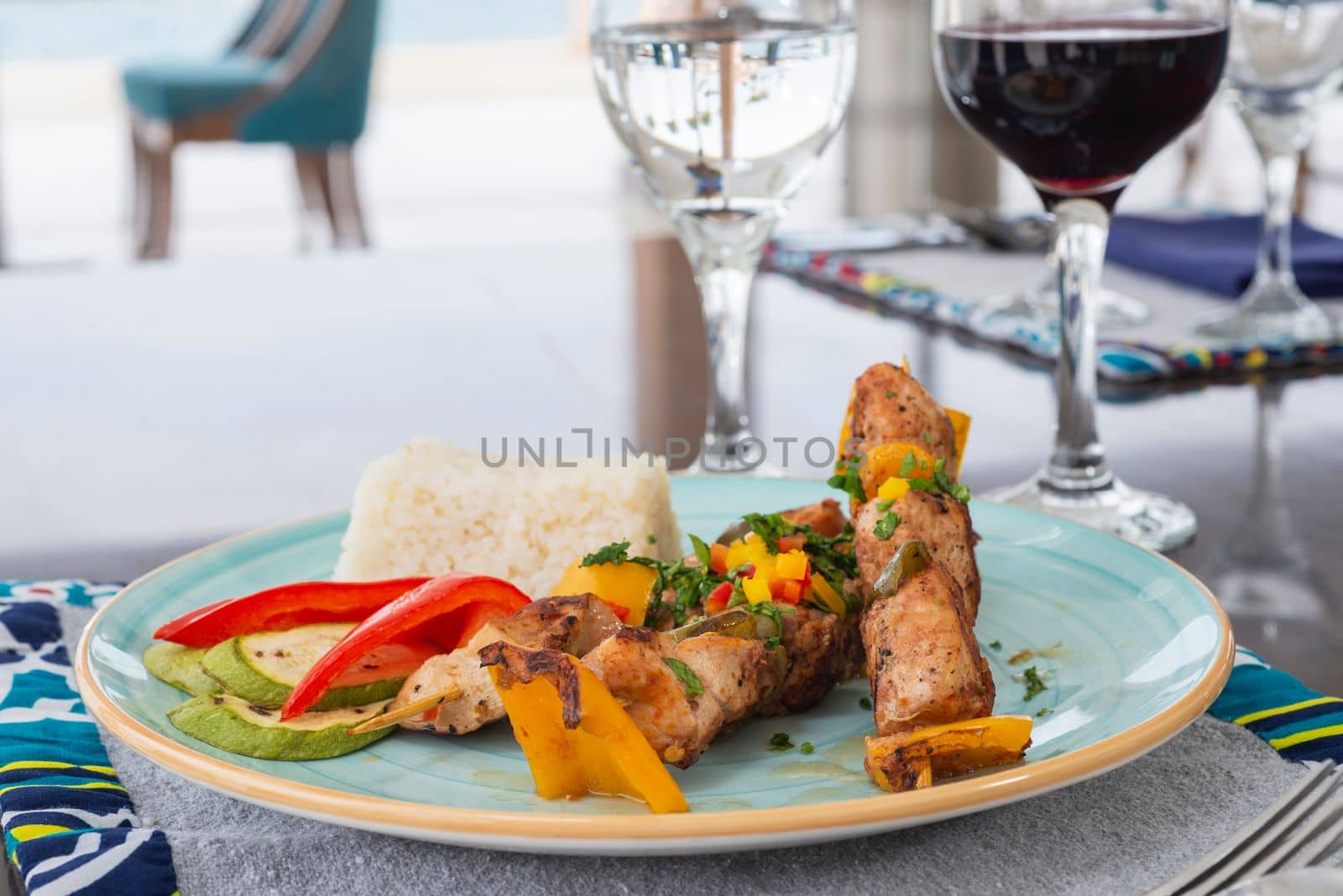 Chicken shish kebab a la carte meal with steamed white rice at restaurant table place setting