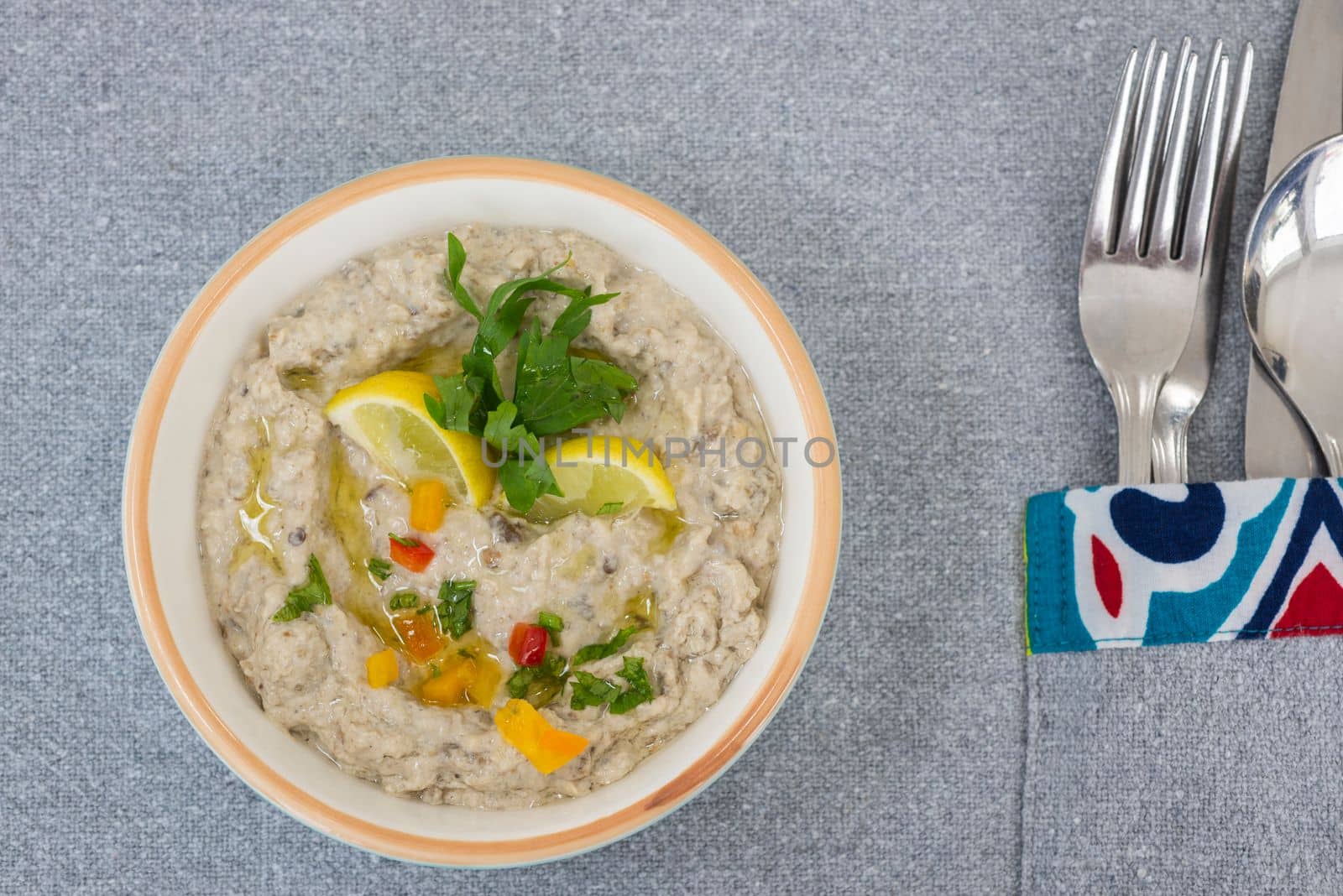 Hummus a la carte appetiser meal side dish dip in a bowl with lemon garnish
