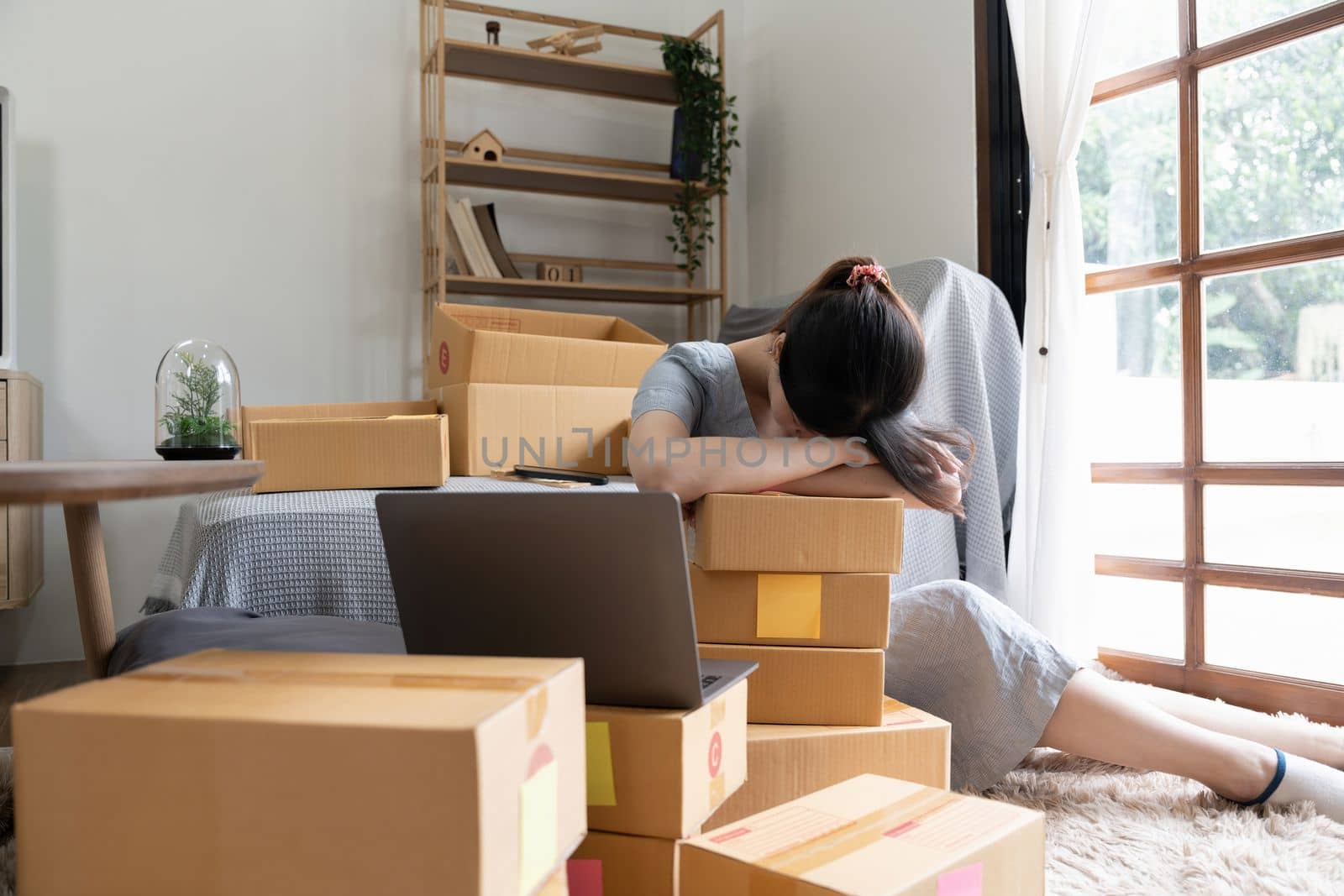 Young startup small business entrepreneur woman packing package post shipping box preparing delivery parcel , Online business, ecommerce and delivery concept. stressed headache.