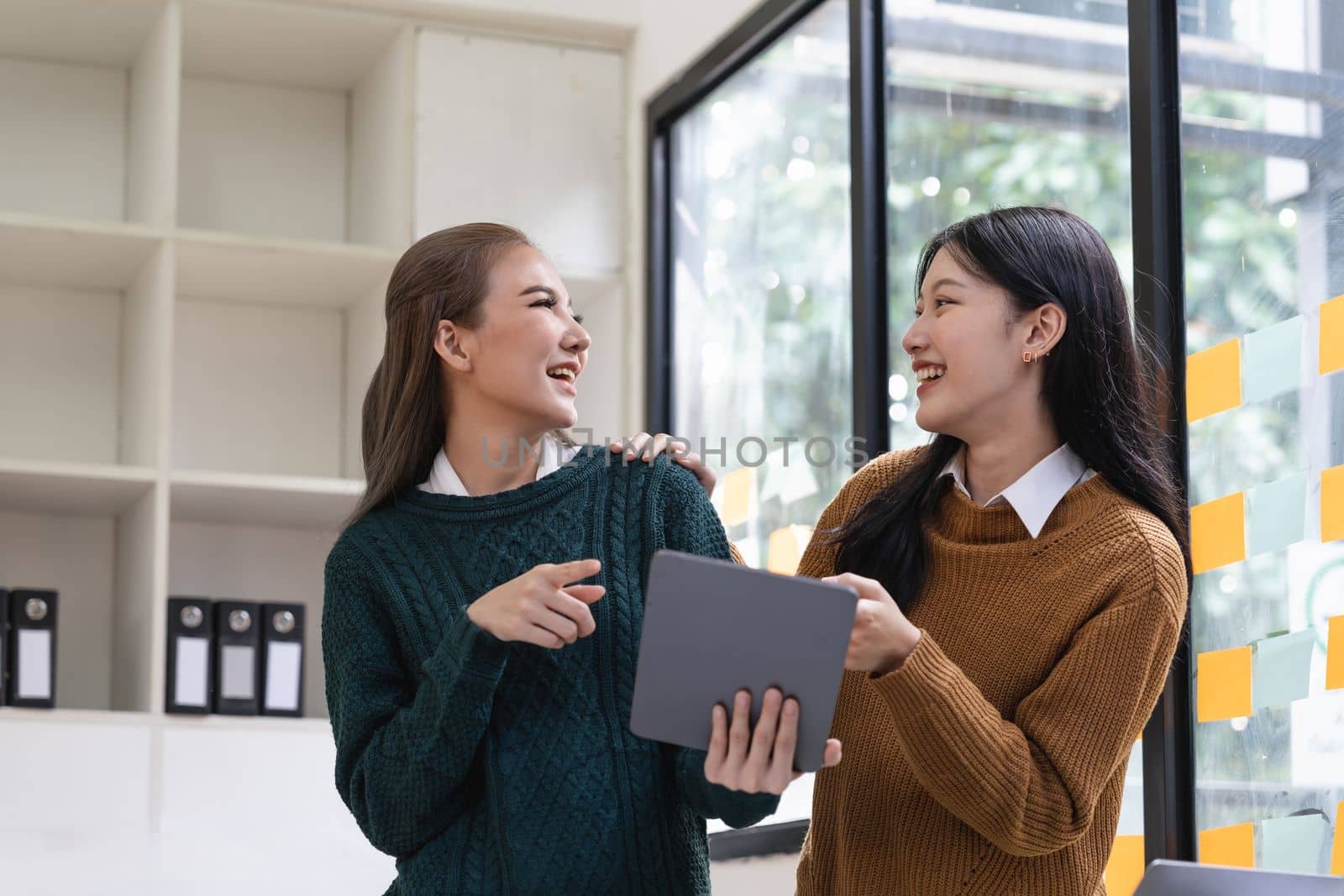diverse coworkers working together in boardroom, brainstorming, discussing and analyzing and planning business strategy