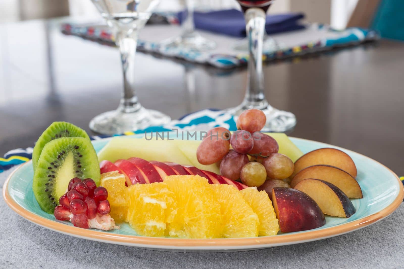 Selection of fresh fruit platter on a plate at restaurant table setting