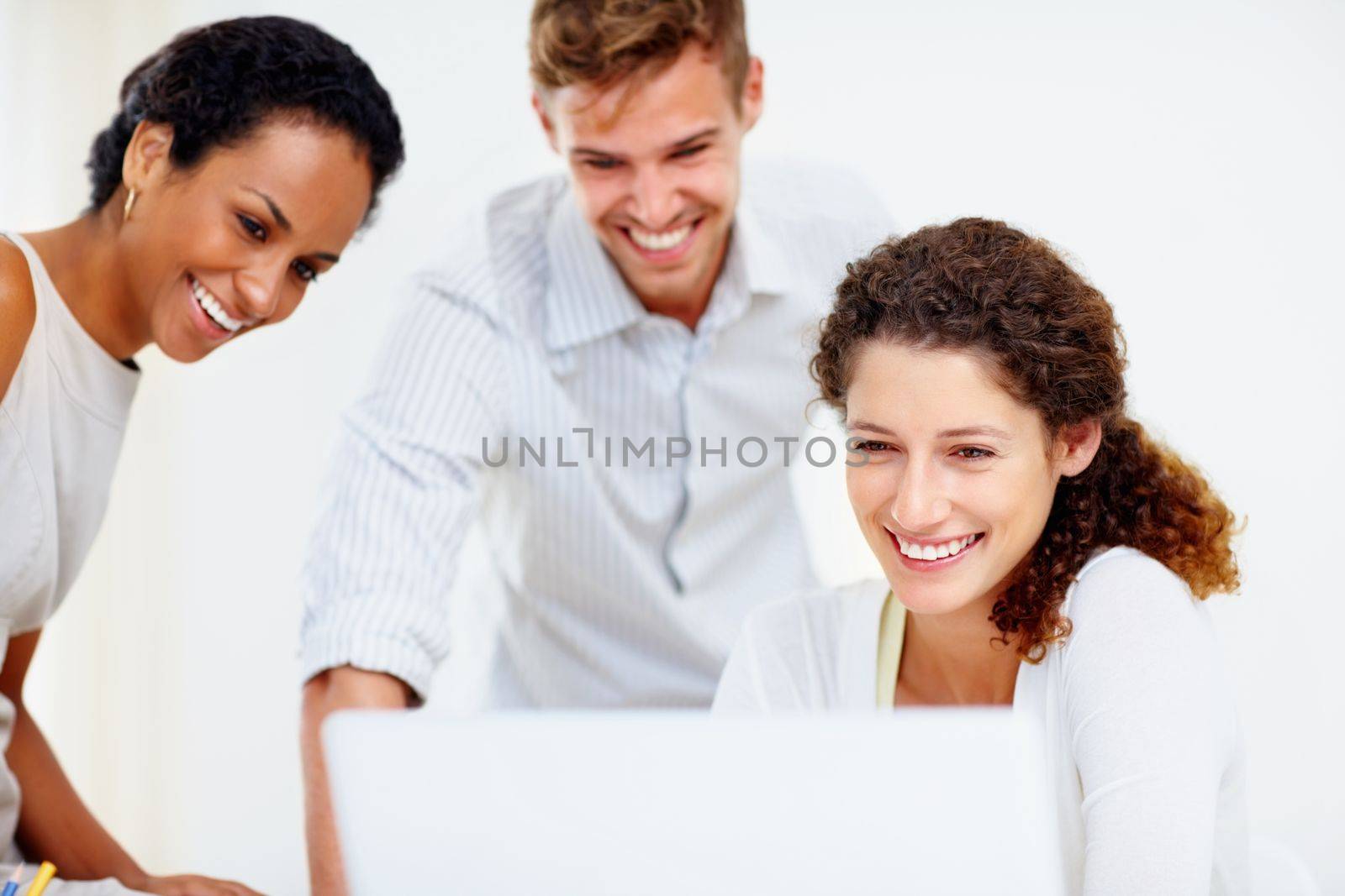 Business people working on laptop. Business people looking at laptop screen and smiling. by YuriArcurs