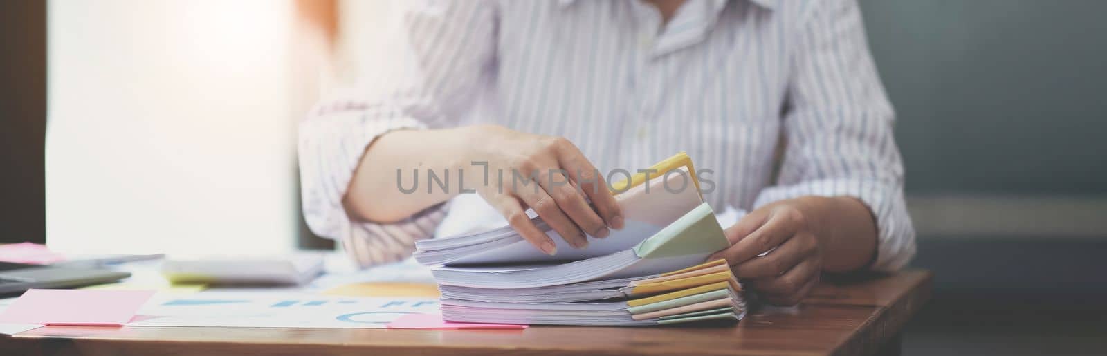 Business Documents, Auditor businesswoman checking searching document legal prepare paperwork or report for analysis TAX time,accountant Documents data contract partner deal in workplace office by wichayada