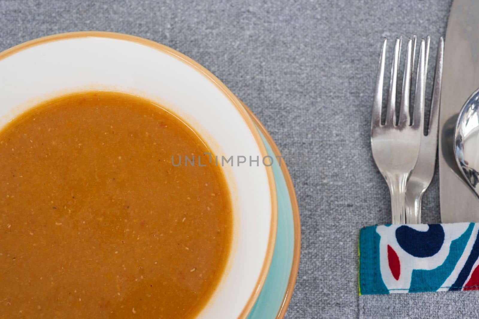 Lentil soup a la carte meal in a bowl with cutlery by paulvinten