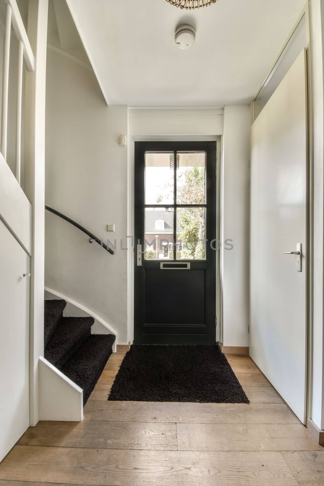 Cozy hallway with stairway leading to second floor