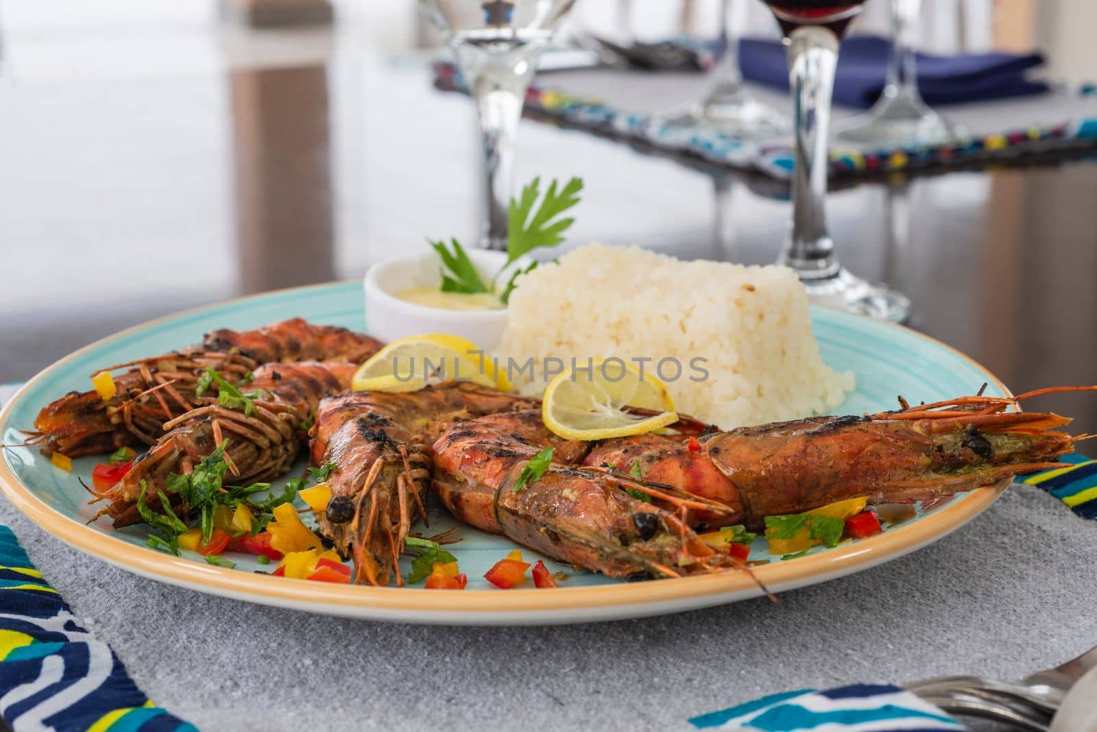 Tiger prawn shrimp a la carte meal with white steamed rice and wine at restaurant table setting