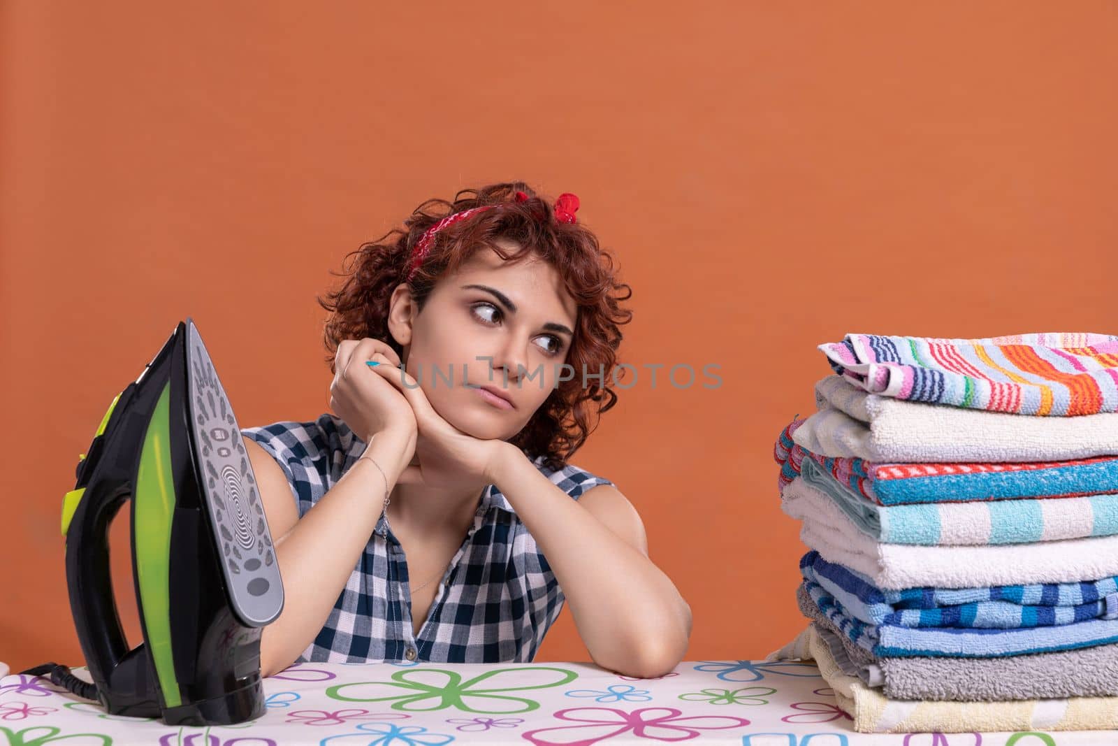 A girl glances at the ironed towels. A woman with big beautiful eyes. It's time to relax after doing the daily work at home.
