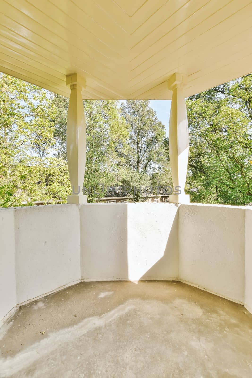 an empty balcony with trees in the background and sunlight shining through the window panoray image is taken from inside