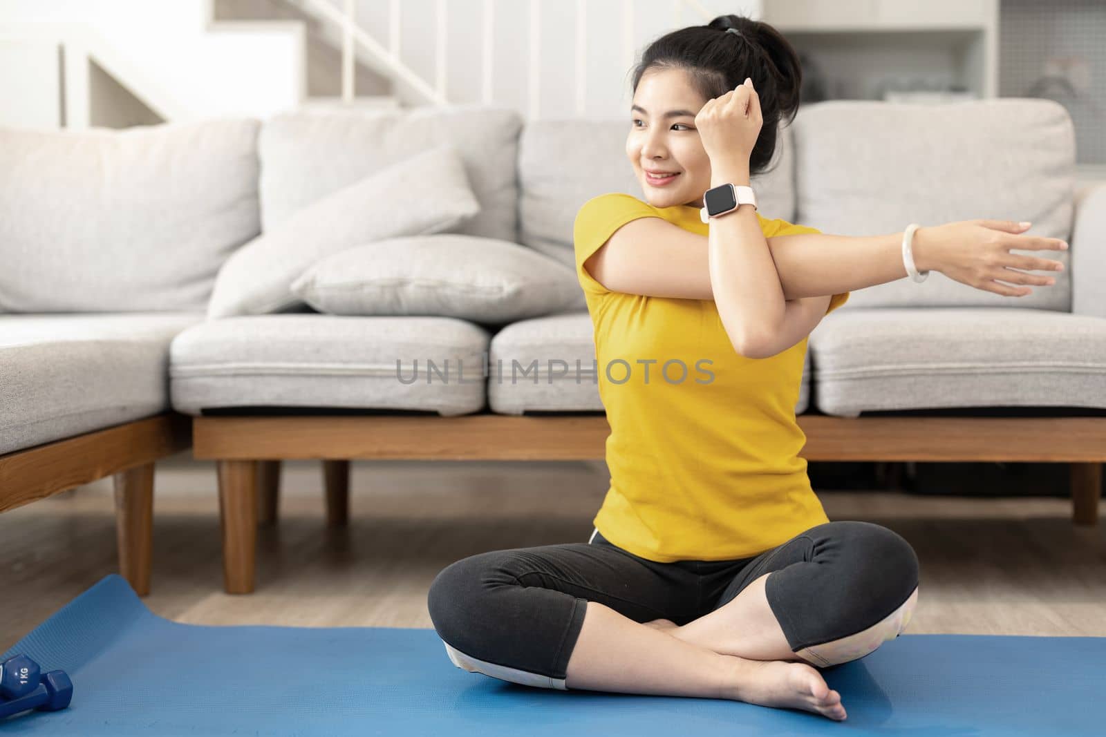 Attractive young woman doing yoga stretching yoga online at home. Self-isolation is beneficial, entertainment and education on the Internet. Healthy lifestyle concept.