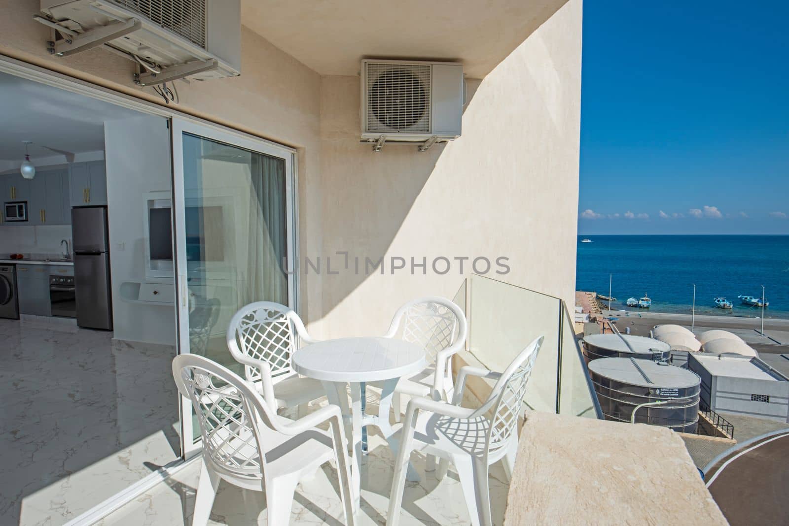 Terrace furniture of a luxury apartment in tropical resort with furniture and sea view from balcony