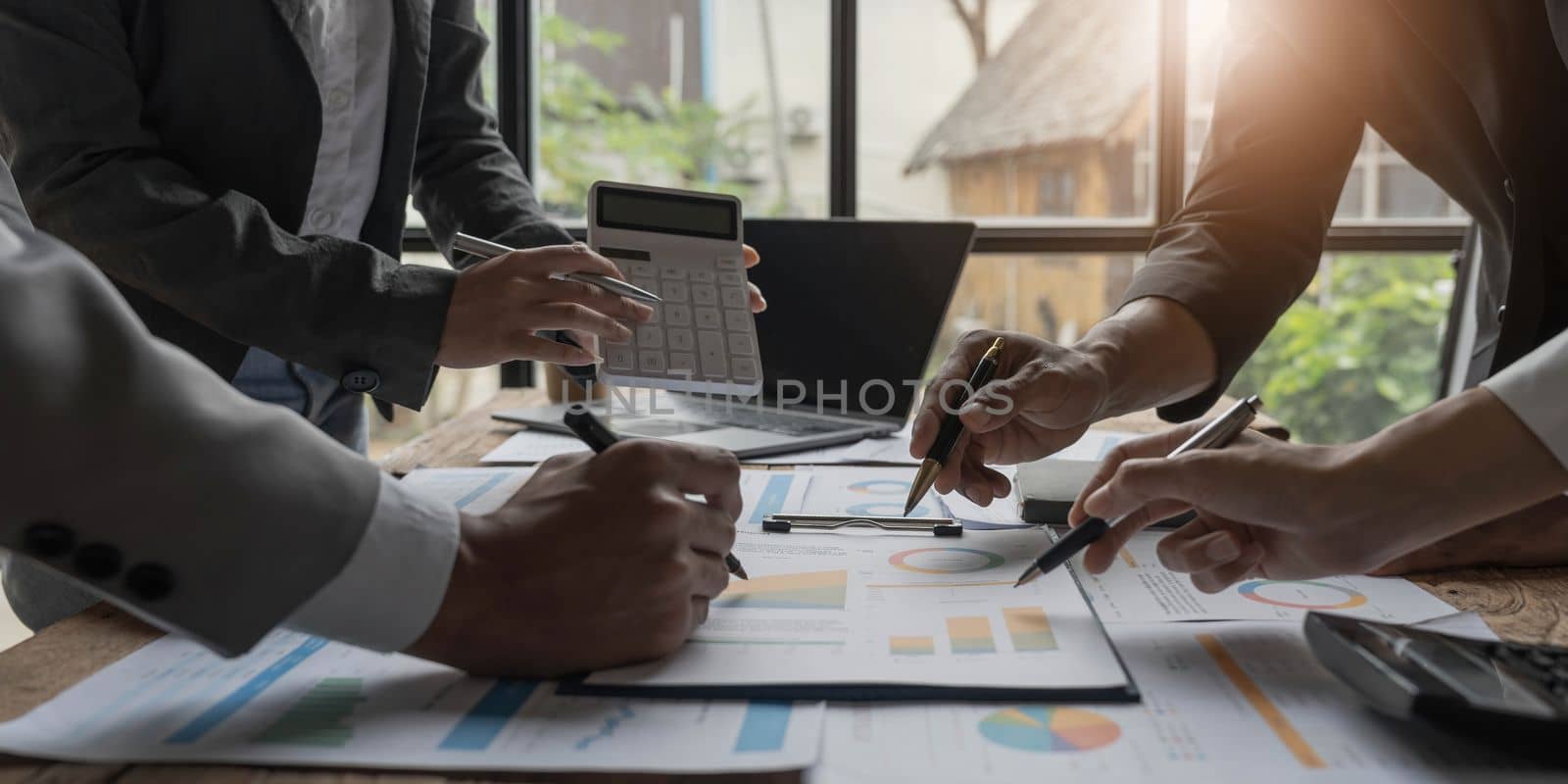 Asian business adviser meeting to analyze and discuss the situation on the financial report in the meeting room.Investment Consultant,Financial Consultant,Financial advisor and accounting concept.