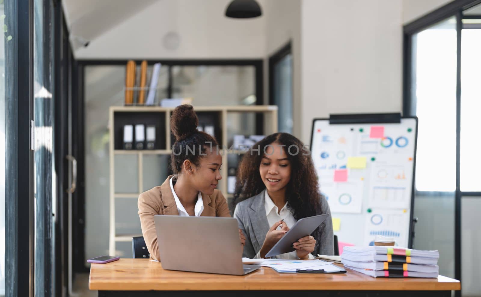 Two young business people working together in office. financial analysis accounting concept