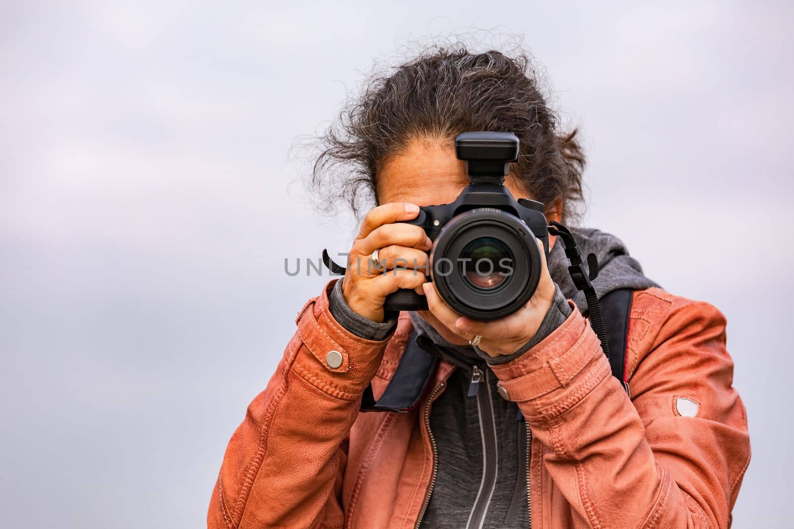 Pretty woman as professional photographer with black camera