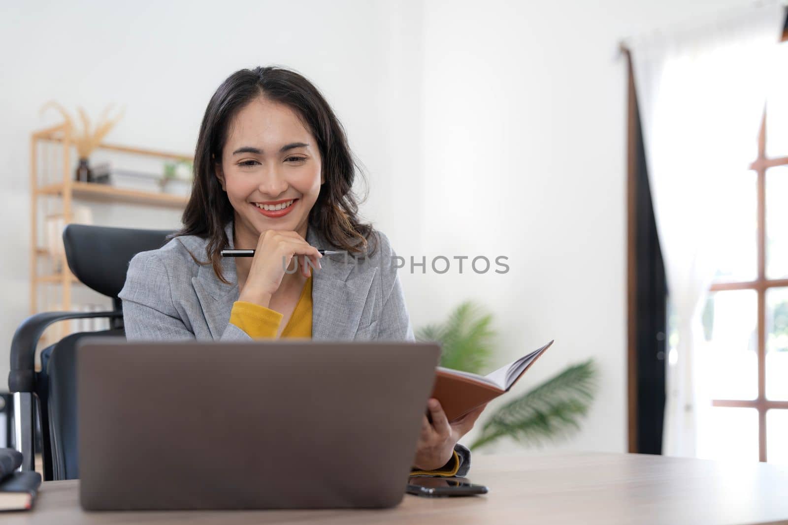 Portrait of an Asian young business Female working on a laptop computer in her workstation.Business people employee freelance online report marketing concept