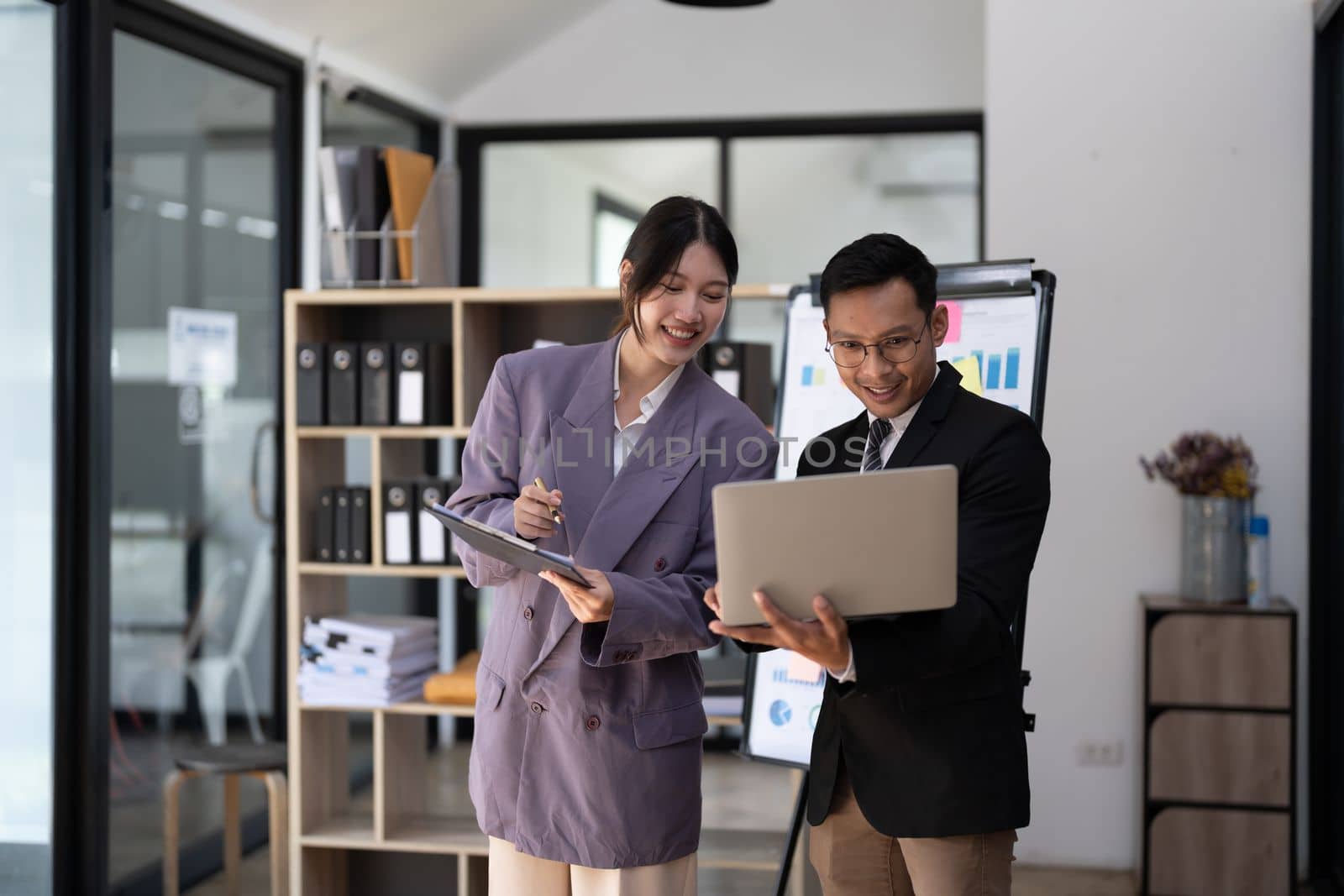 panoramic banner. business people meet and discuss chart and point at chart Company report share marketing in the office. Business team stand to discuss and work together at the office.