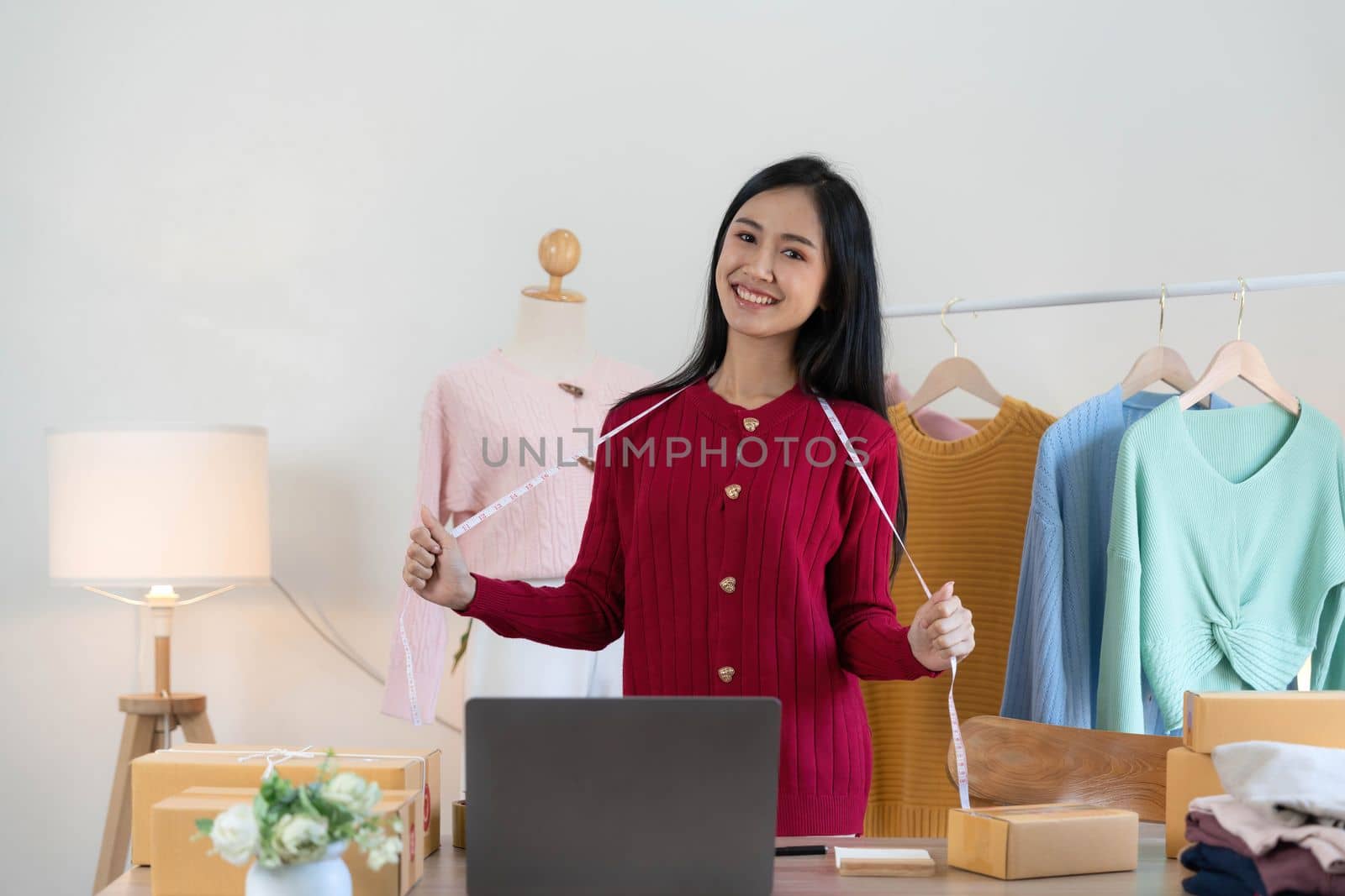 Portrait of Starting small businesses SME owners, Asian woman check online orders Selling products working with boxs freelance work at home office, sme business online small medium enterprise..