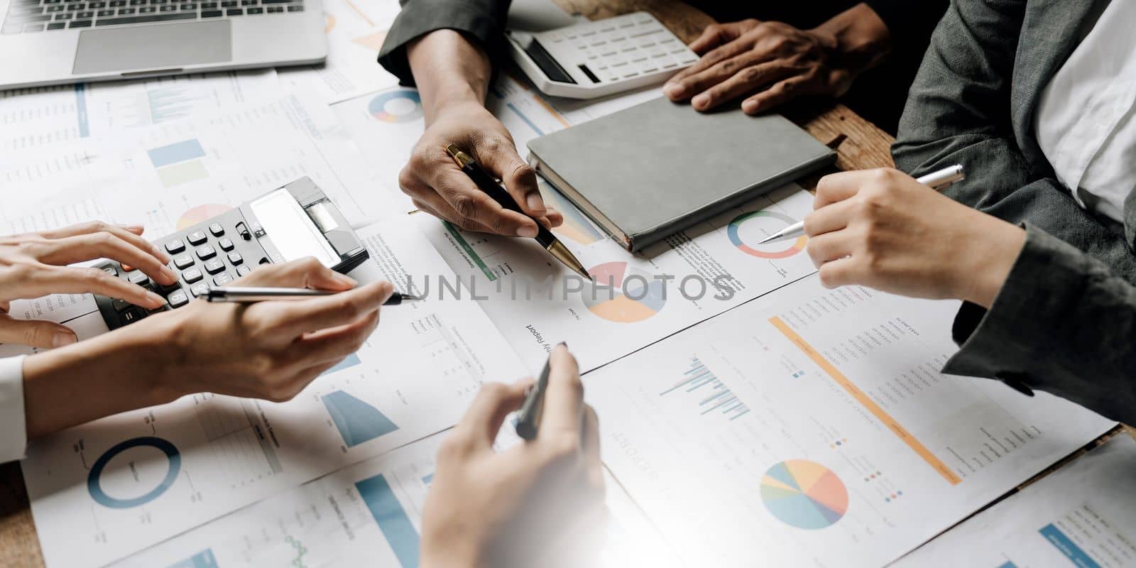 Asian business adviser meeting to analyze and discuss the situation on the financial report in the meeting room.Investment Consultant,Financial Consultant,Financial advisor and accounting concept by wichayada