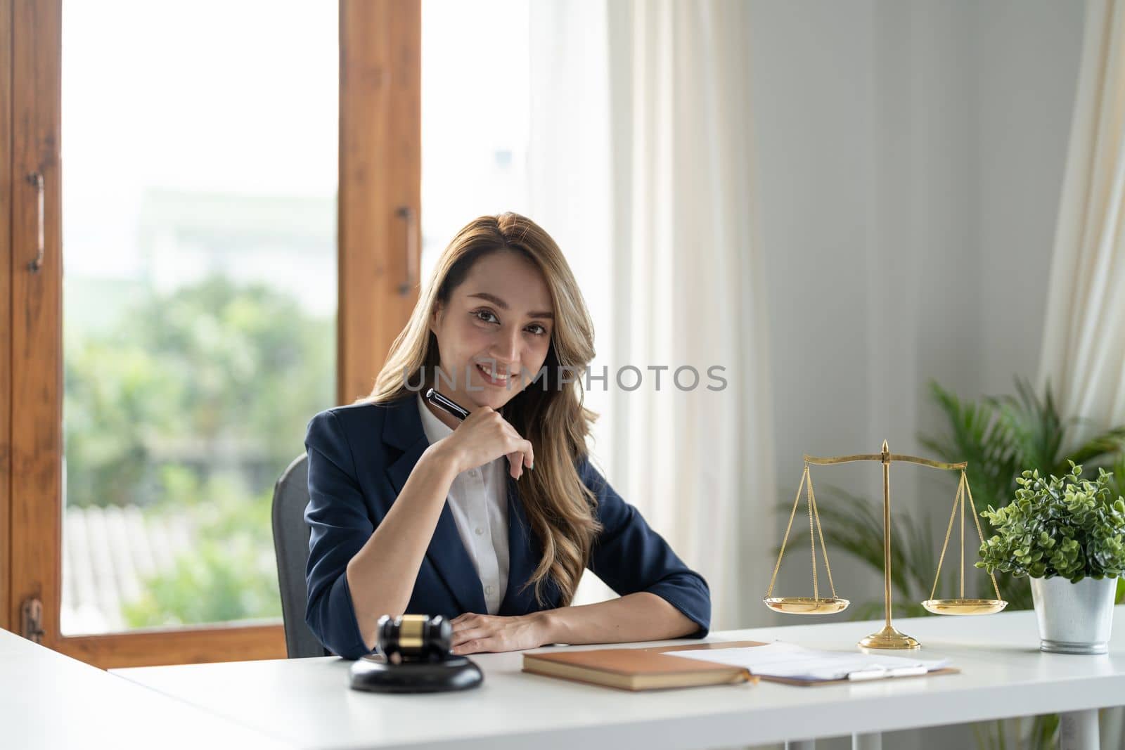 Business woman and lawyers discussing contract papers with brass scale on wooden desk in office. Law, legal services, advice, Justice and real estate concept