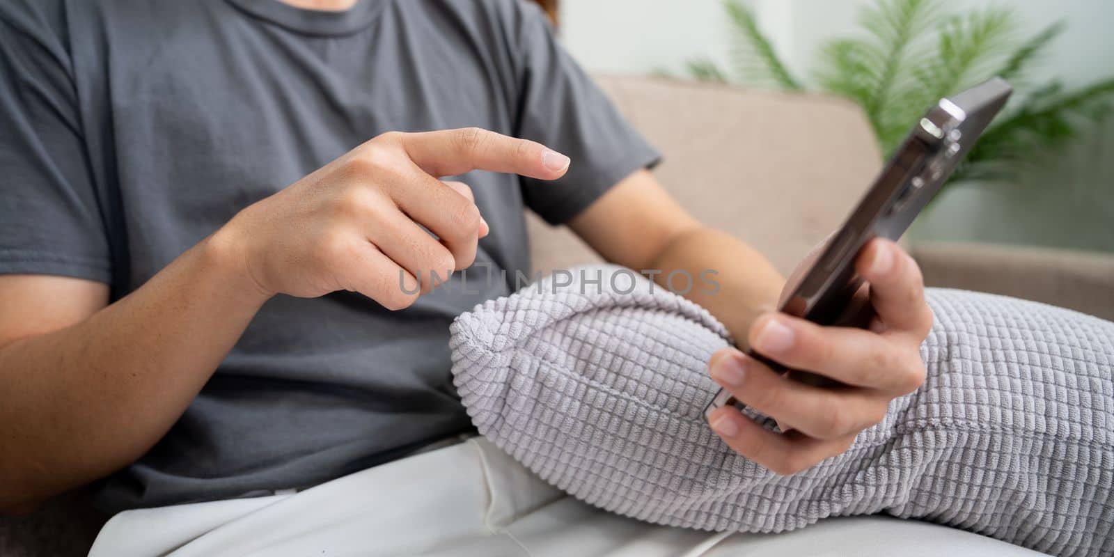 Close up of man hands using mobile smartphone at home, Searching or social networks concept