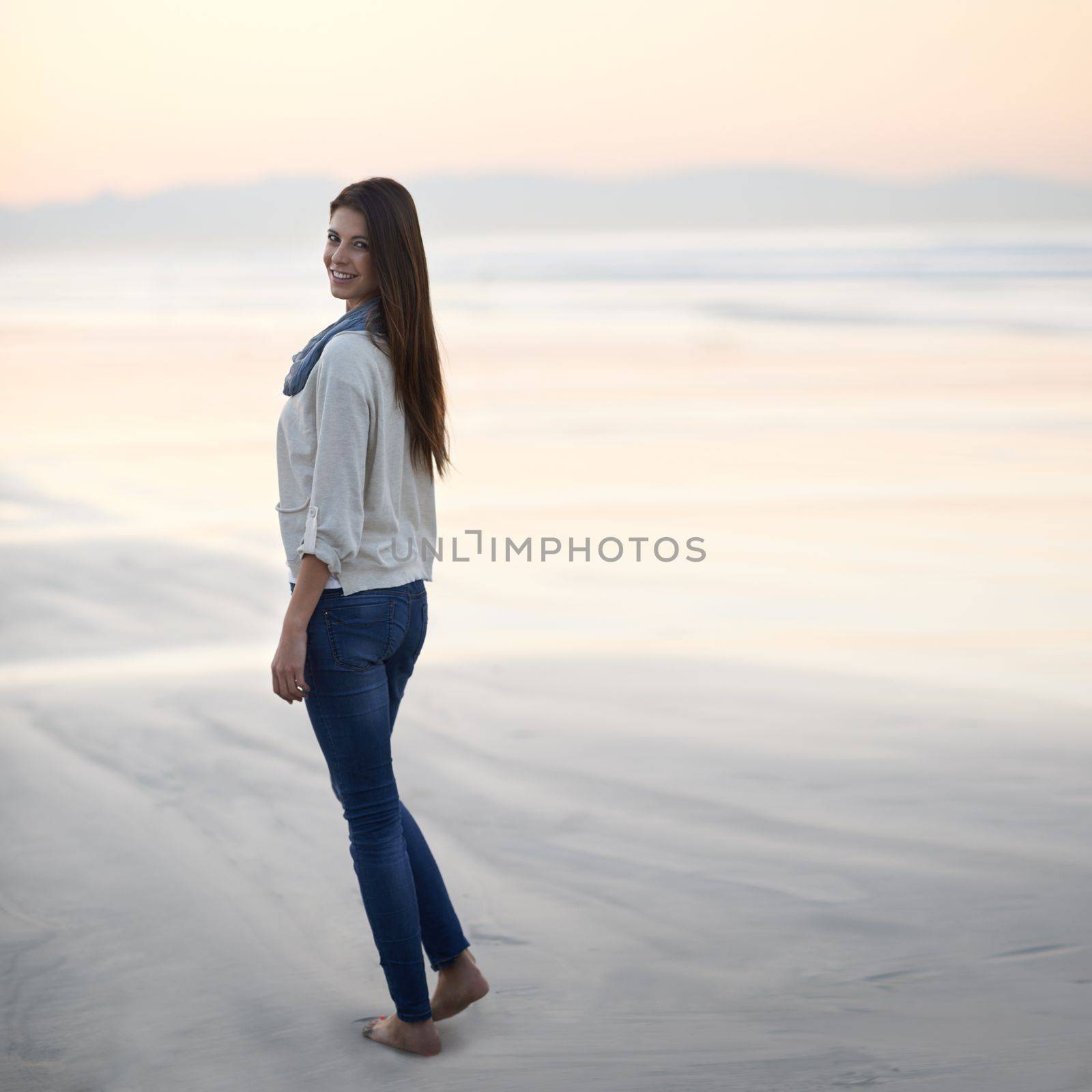 Loving the seaside vacation. a young woman at the beach. by YuriArcurs