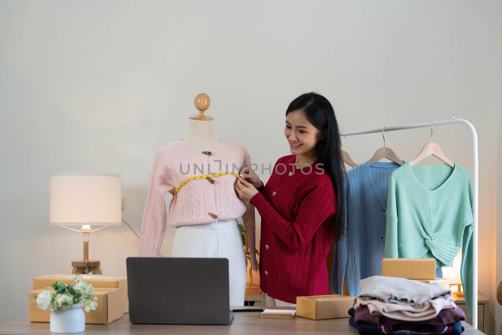 Portrait of Starting small businesses SME owners, Asian woman check online orders Selling products working with boxs freelance work at home office, sme business online small medium enterprise..