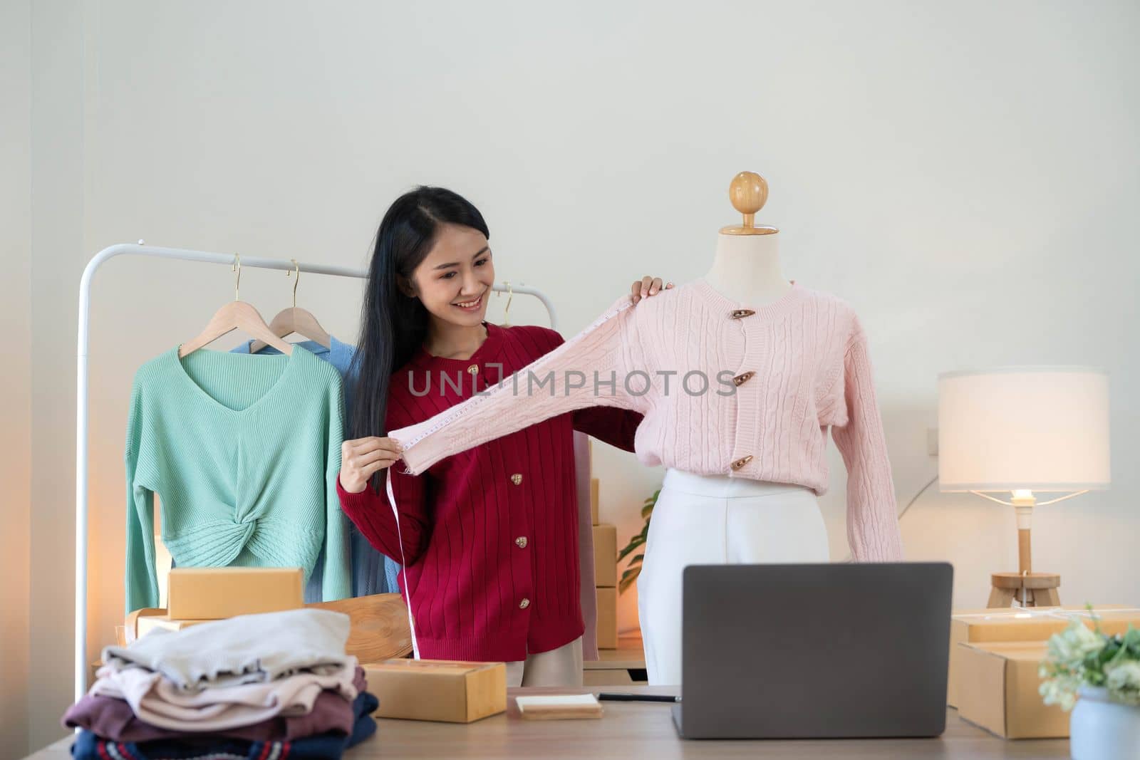 Portrait of Starting small businesses SME owners, Asian woman check online orders Selling products working with boxs freelance work at home office, sme business online small medium enterprise..