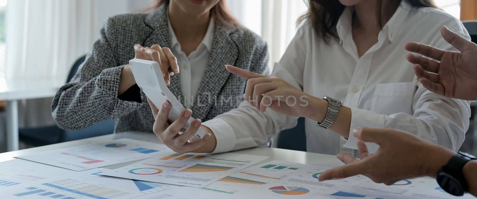 Asian business adviser meeting to analyze and discuss the situation on the financial report in the meeting room.Investment Consultant,Financial Consultant,Financial advisor and accounting concept.