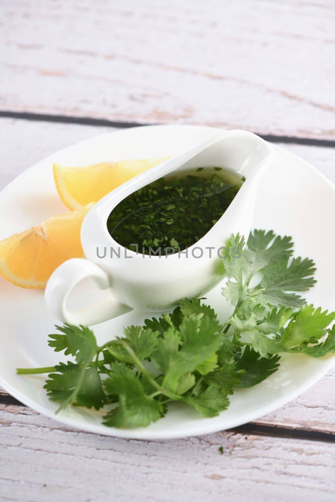 Green delicious herbal marinade of cilantro, basil, parsley, oil, traditional seasoning for salad dressing