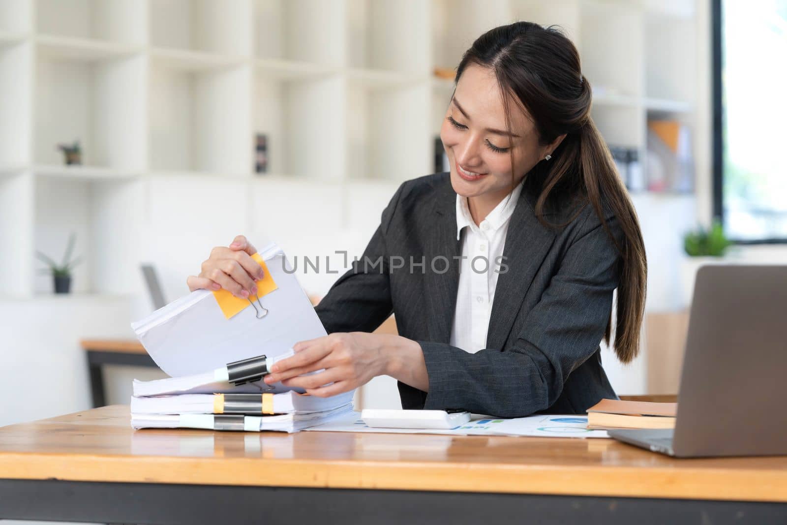 Business Documents, Auditor businesswoman checking searching document legal prepare paperwork or report for analysis TAX time,accountant Documents data contract partner deal in workplace office.