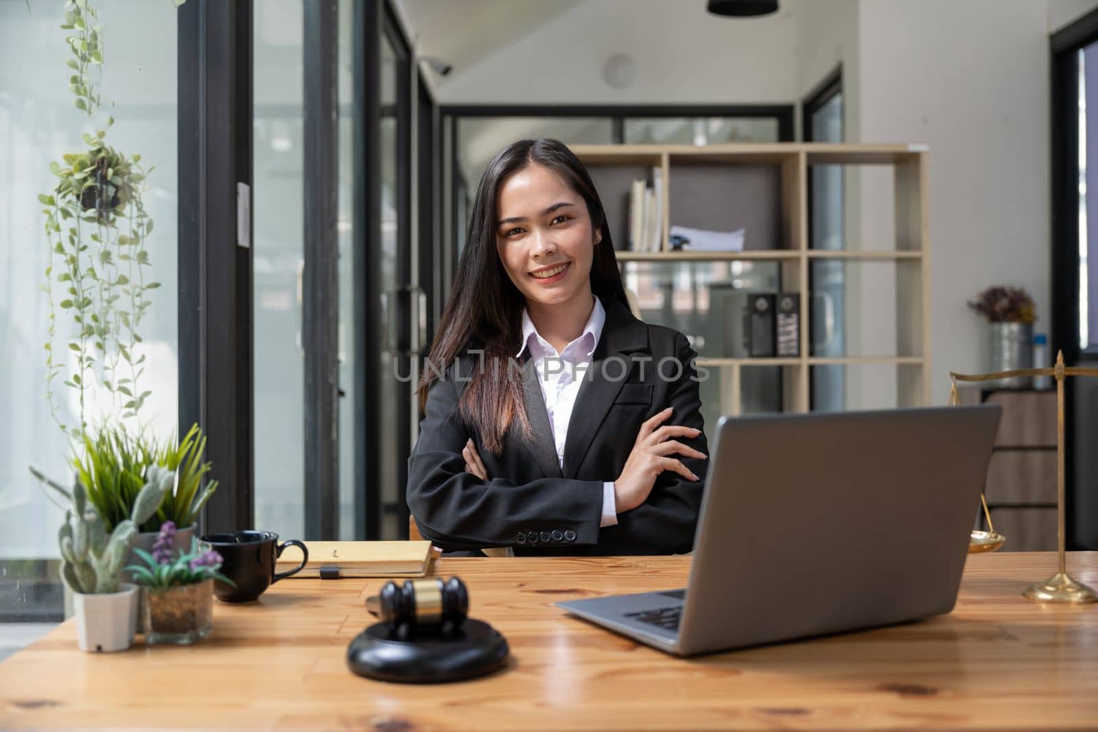 Asian business lawyer woman smiling at camera at workplace in an office.